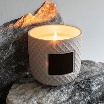 How To Use A Lotion Candle And Enjoy Its Wonderful Skin Benefits lotion candle on stone | how to use a lotion candle