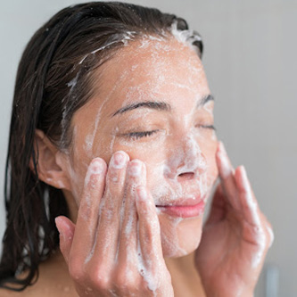 Alcohol In Skin Care: Is It Okay For Your Skin? lady washing her face | alcohol in skin care
