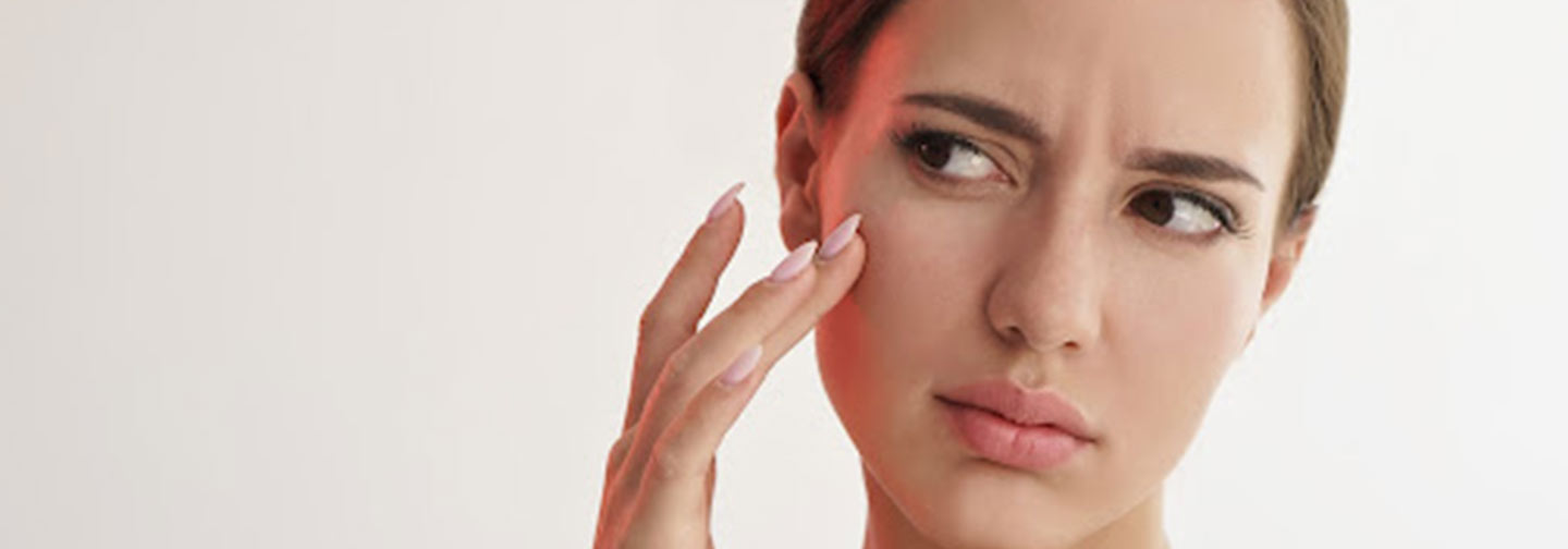 lady touching her face | why are parabens bad