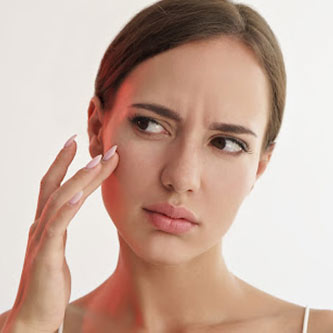 Why Are Parabens Bad For The Skin lady touching her face | why are parabens bad