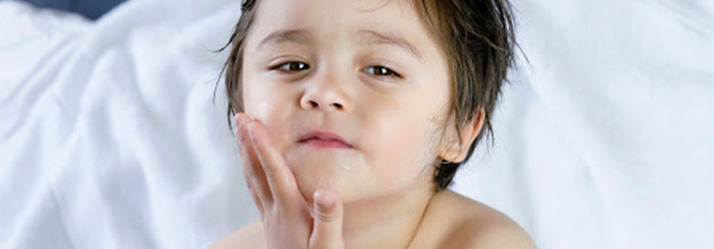 kid touching his face | lotion candle for kids